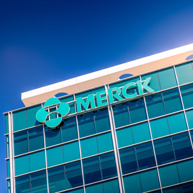 Merck's logo on an office building against the blue sky — coverage from STAT