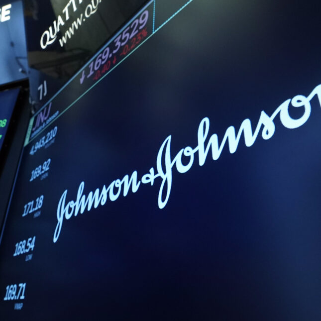 The New York Stock Exchange's screen displays a logo of Johnson & Johnson — pharma coverage from STAT