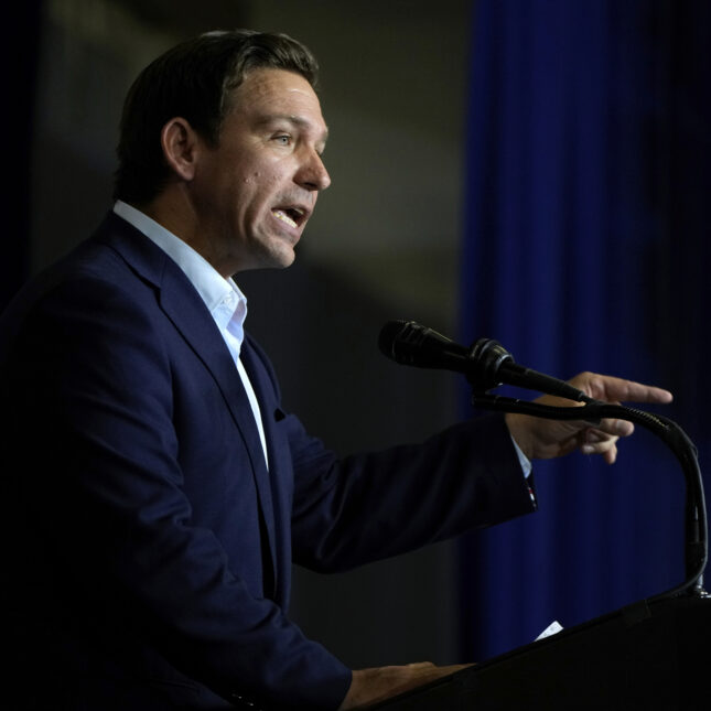 Photograph of Ron DeSantis pointing. -- health policy coverage from STAT