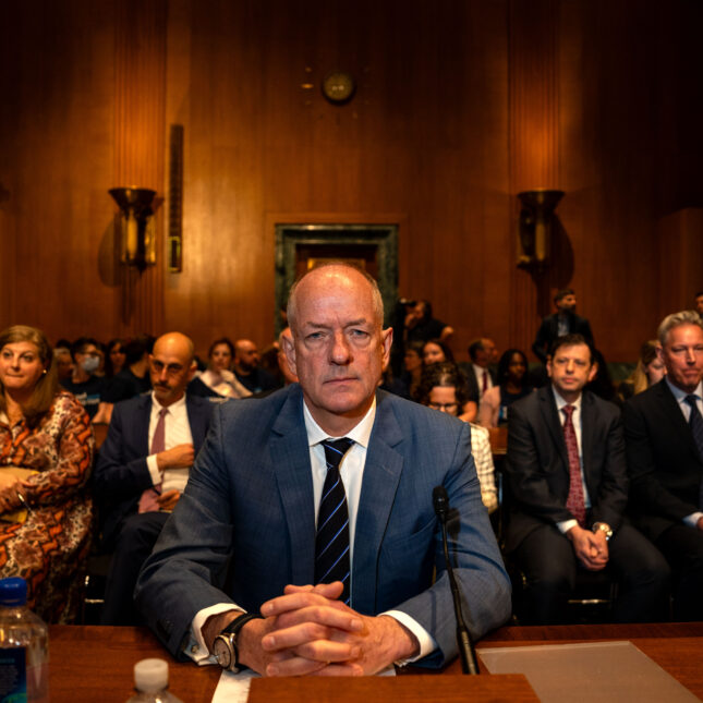 UnitedHealth's CEO Andrew Witty stares into the camera at a hearing with his fingers locked — politics coverage from STAT