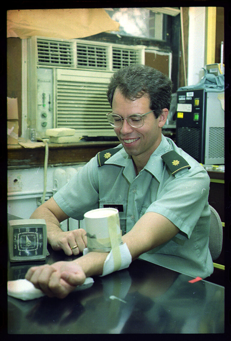 Rip Ballou, who helped lead the development of the RTS,S vaccine, offers his arm up to a mosquito during a study.